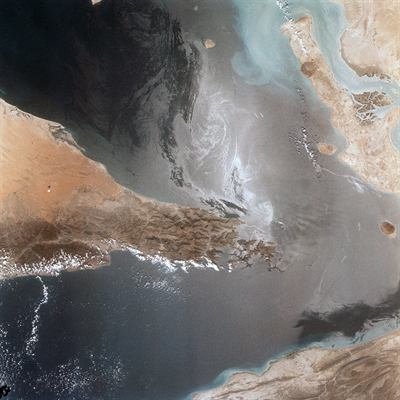 The Strait of Hormuz photographed from orbit, the chokepoint the war closed.